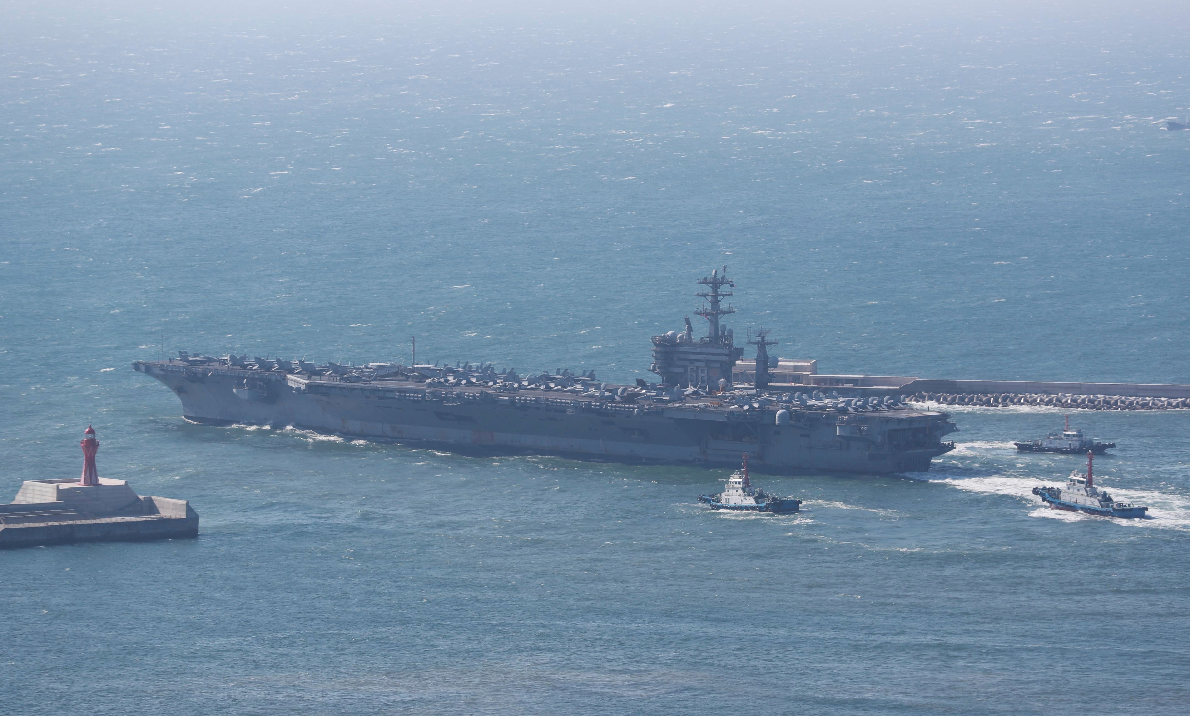 The U.S. Navy's nuclear-powered aircraft carrier USS Nimitz departs a naval base in Busan, South Korea, Sunday, April 2, 2023.