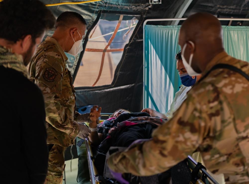 Airmen assigned to the 86th Medical Group provide post-labor care to an Afghan mother who gave birth aboard a U.S. Air Force C-17 Globemaster III, call sign Reach 828, with the aid of U.S. Army Captain Erin Brymer, Landstuhl Regional Medical Center registered nurse, upon landing at Ramstein Air Base, Germany, Aug. 21. During an evacuation flight from an Intermediate Staging Base in the Middle East, the mother went into labor and began experiencing complications due to low blood pressure. The aircraft commander made the decision to descend in altitude to increase air pressure in the aircraft, which helped stabilize and save the mother’s life. Upon landing, Capt. Brymer and 86th Airlift Wing medics came aboard and delivered the child in the cargo bay of the aircraft. The baby girl and mother were transported to a nearby medical facility and are in good condition. (Airman Edgar Grimaldo/Air Force)