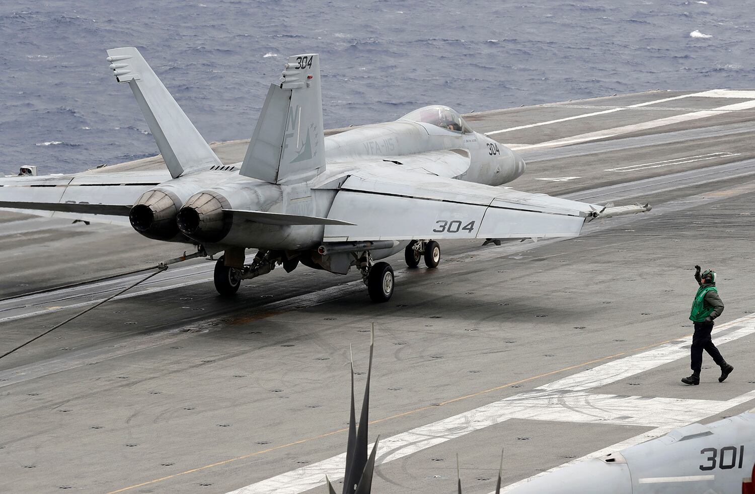 A U.S. fighter jet lands on the U.S. aircraft carrier USS Ronald Reagan following their patrol at the international waters off South China Sea Tuesday, Aug. 6, 2019.