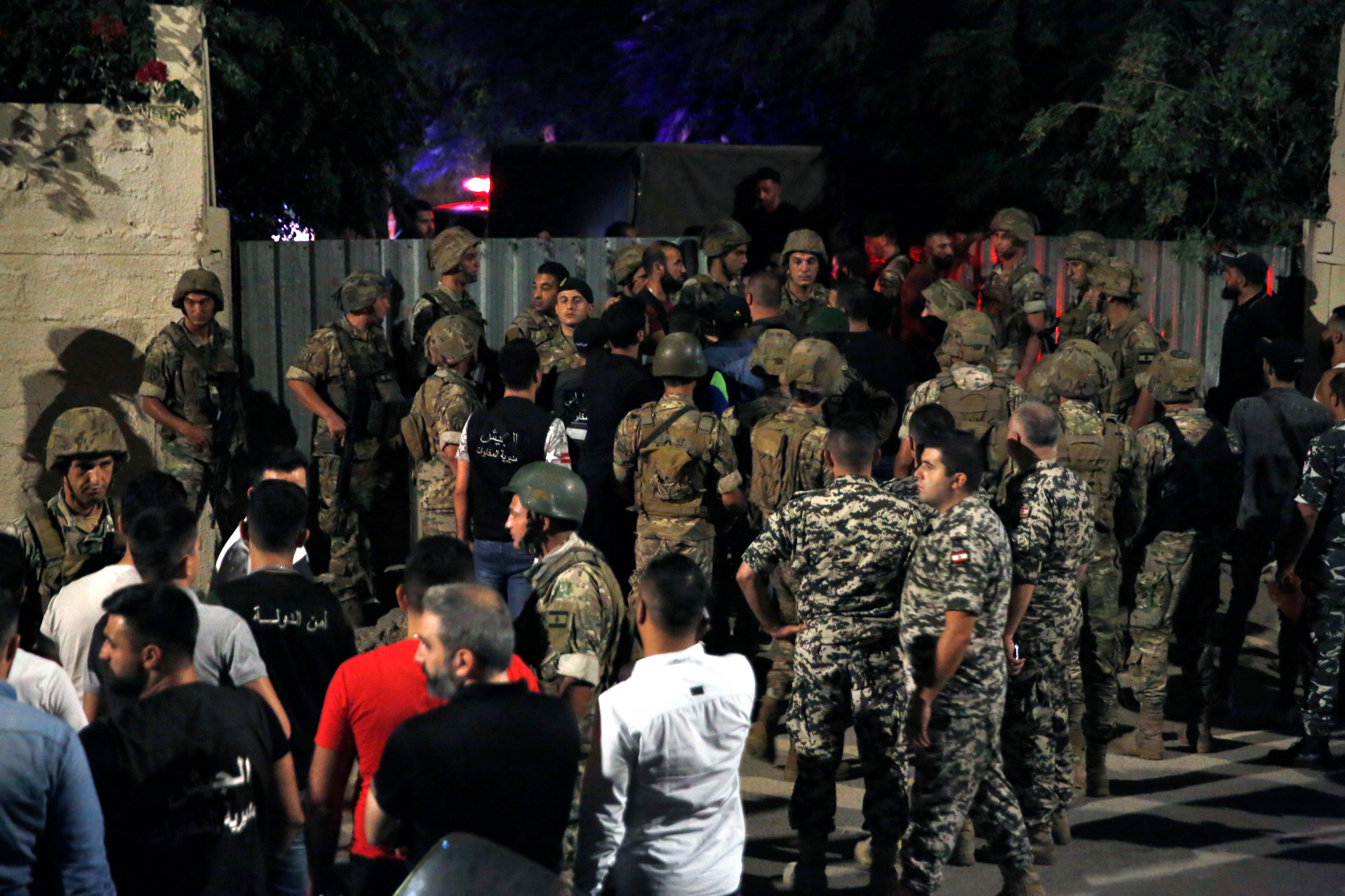 Lebanese security stand near the site where an Israeli drone was said to have crashed in a stronghold of the Lebanese Hezbollah group, in a southern suburb of Beirut, Lebanon, Sunday, Aug. 25, 2019.