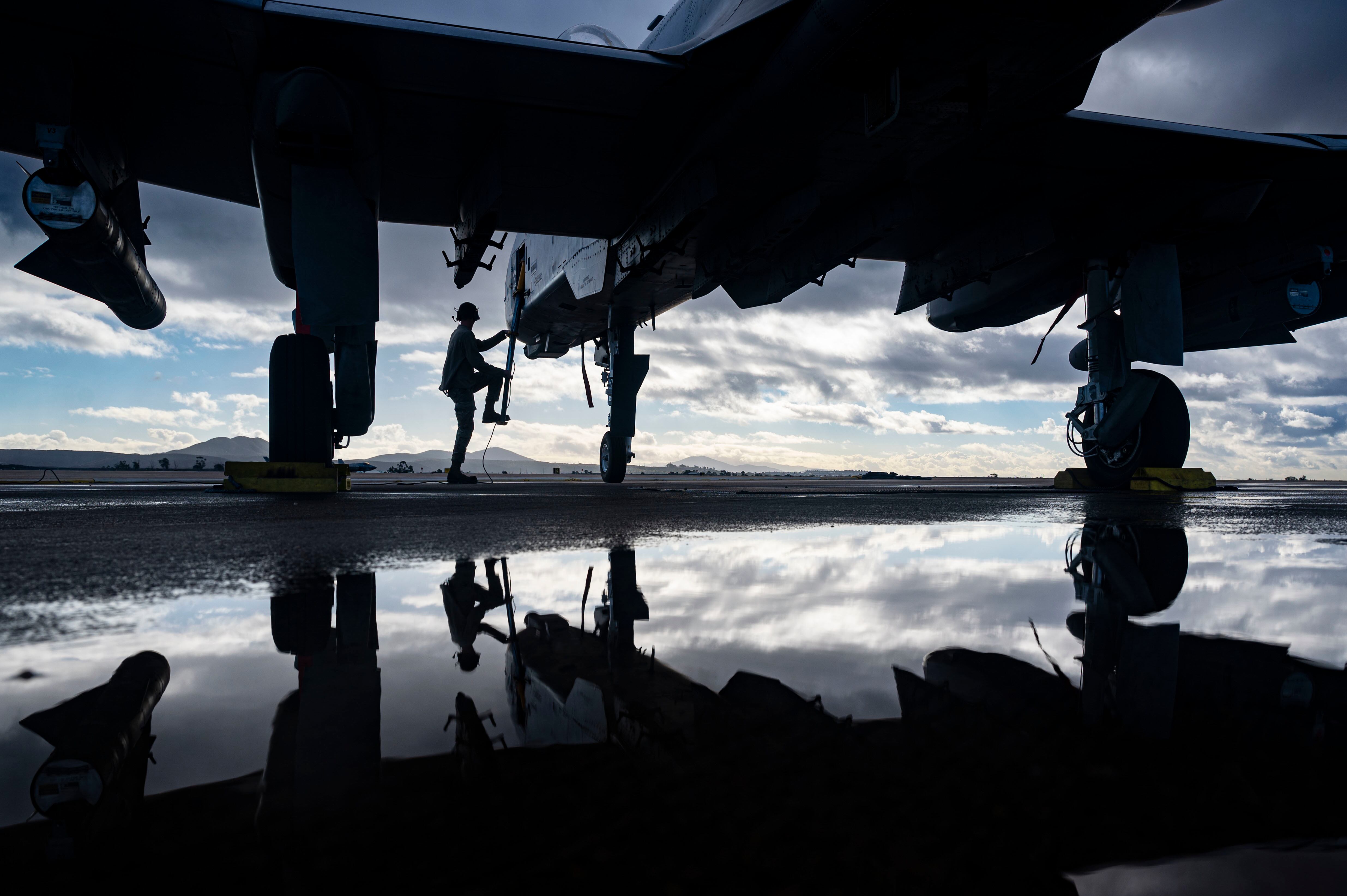 Airman 1st Class Dylan Prusso, 75th Fighter Generation Squadron crew chief, Moody Air Force Base, Ga., climbs up onto an A-10C Thunderbolt II during exercise Green Flag-West 23-02 at Marine Corps Air Station Miramar, Calif., Nov. 9, 2022. The 549th Combat Training Squadron completed the Green Flag-West exercise Nov. 2-9, integrating U.S. Navy and U.S. Air Force command and control, tactical units, and intelligence, surveillance and reconnaissance, while operating from multiple locations across the West Coast. (Senior Airman Zachary Rufus/Air Force)