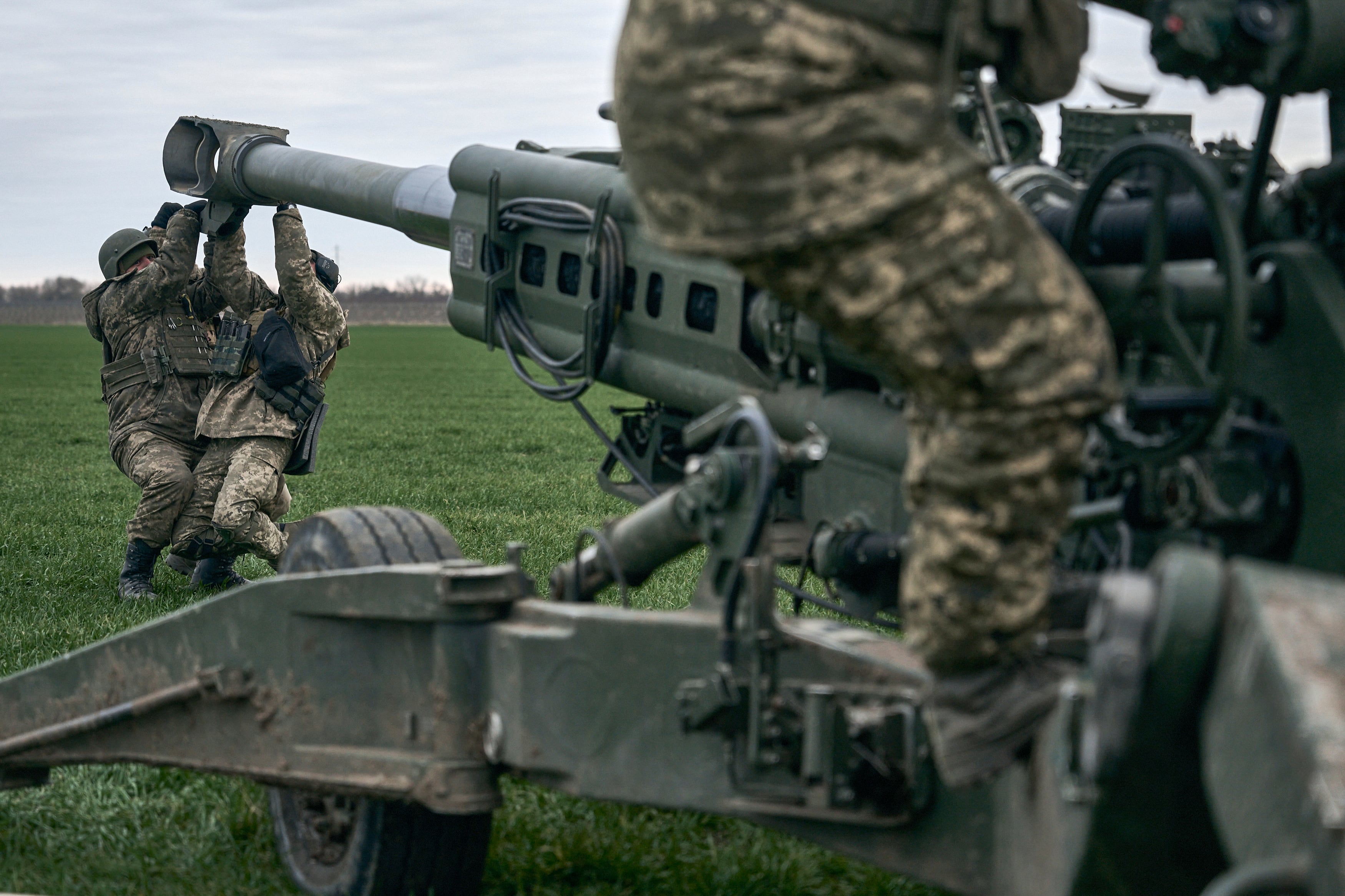 Ukrainian soldiers prepare a U.S.-supplied M777 howitzer to fire at Russian positions in Kherson region, Ukraine, Jan. 9, 2023.