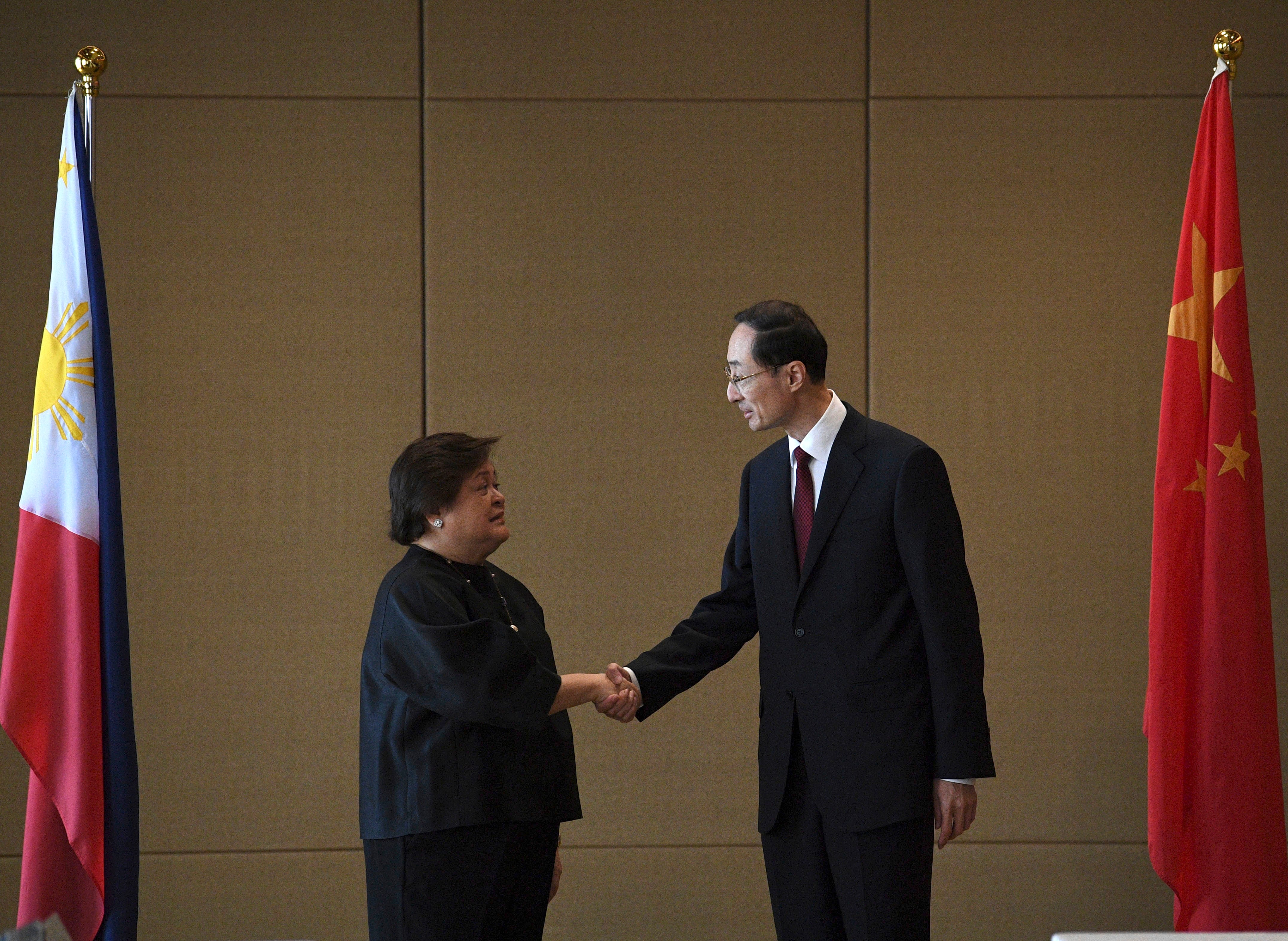 Theresa Lazaro, left, Philippines' Undersecretary for Bilateral Relations and Asian Affairs of the Department of Foreign Affairs, shake hands with Sun Weidong, China's Vice Foreign Minister, prior to the start of the Philippines-China Foreign Ministry consultation meeting at a hotel in Manila on Thursday, March 23, 2023.