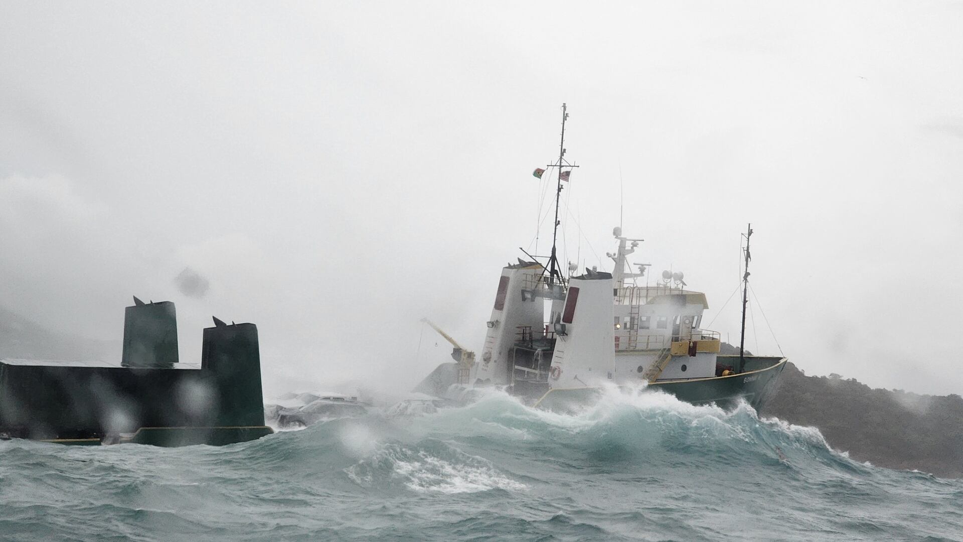 The U.S. Coast Guard says it has rescued 12 people who abandoned a large cargo ship, named Bonnie G, that ran aground near the U.S. Virgin Islands.