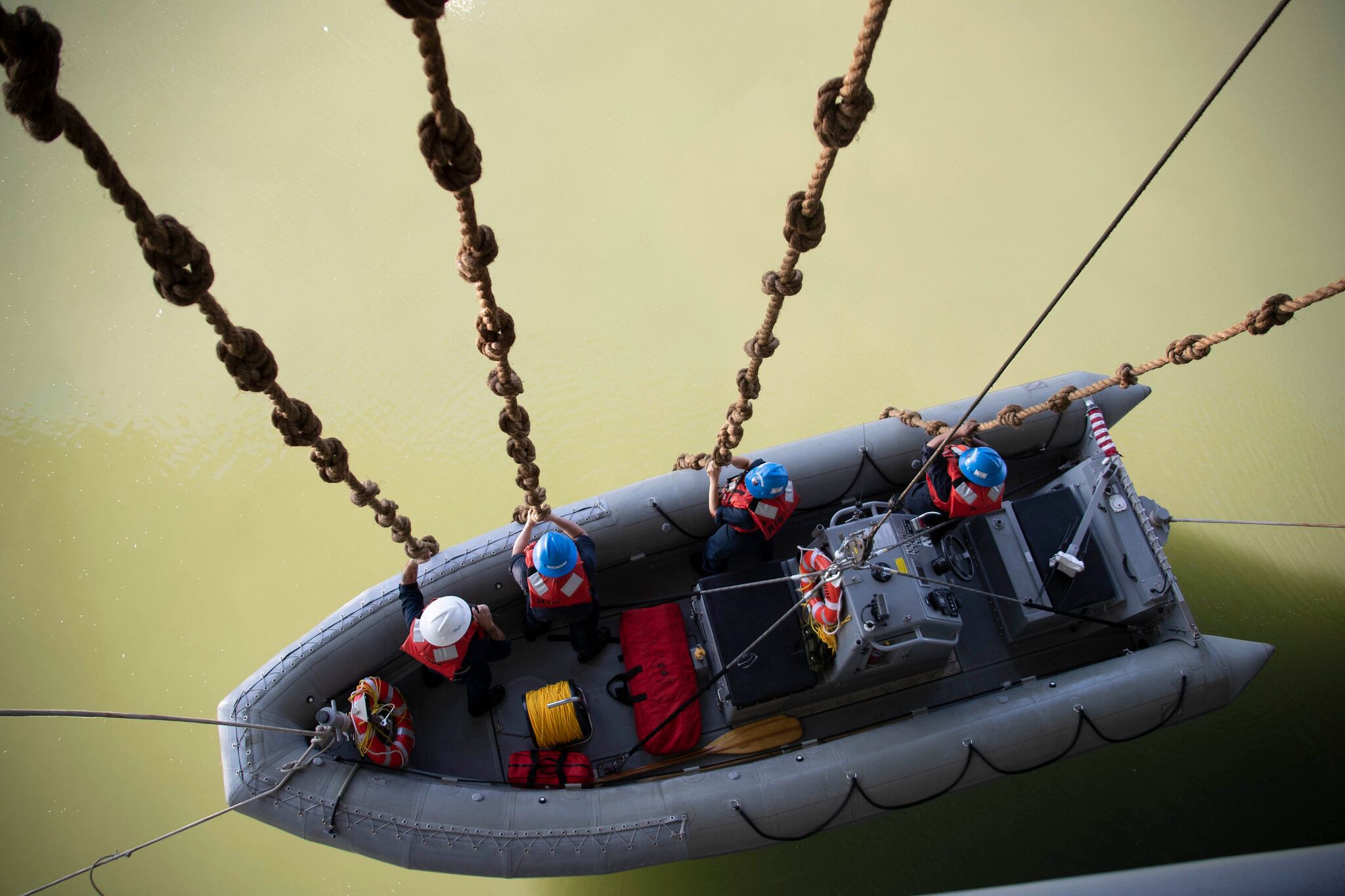 Sailors assigned to USS Gerald R. Ford (CVN 78) are lowered into the water during a small boat operations exercise in Newport News, Va., July 10, 2019.