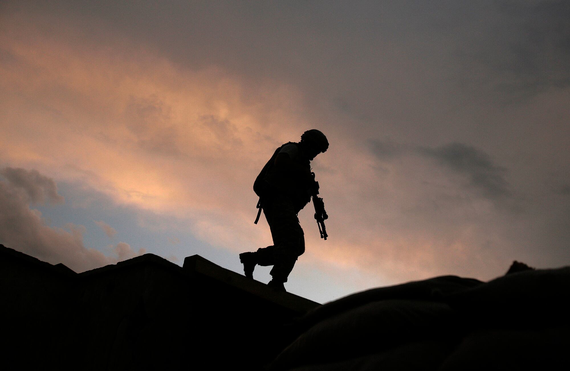 In this Sept. 18, 2009, file, photo, a soldier from the U.S. Army's 118th Military Police Co., based at Fort Bragg, N.C., respond to shots fired at a combat outpost in the Jalrez Valley in Afghanistan's Wardak Province.