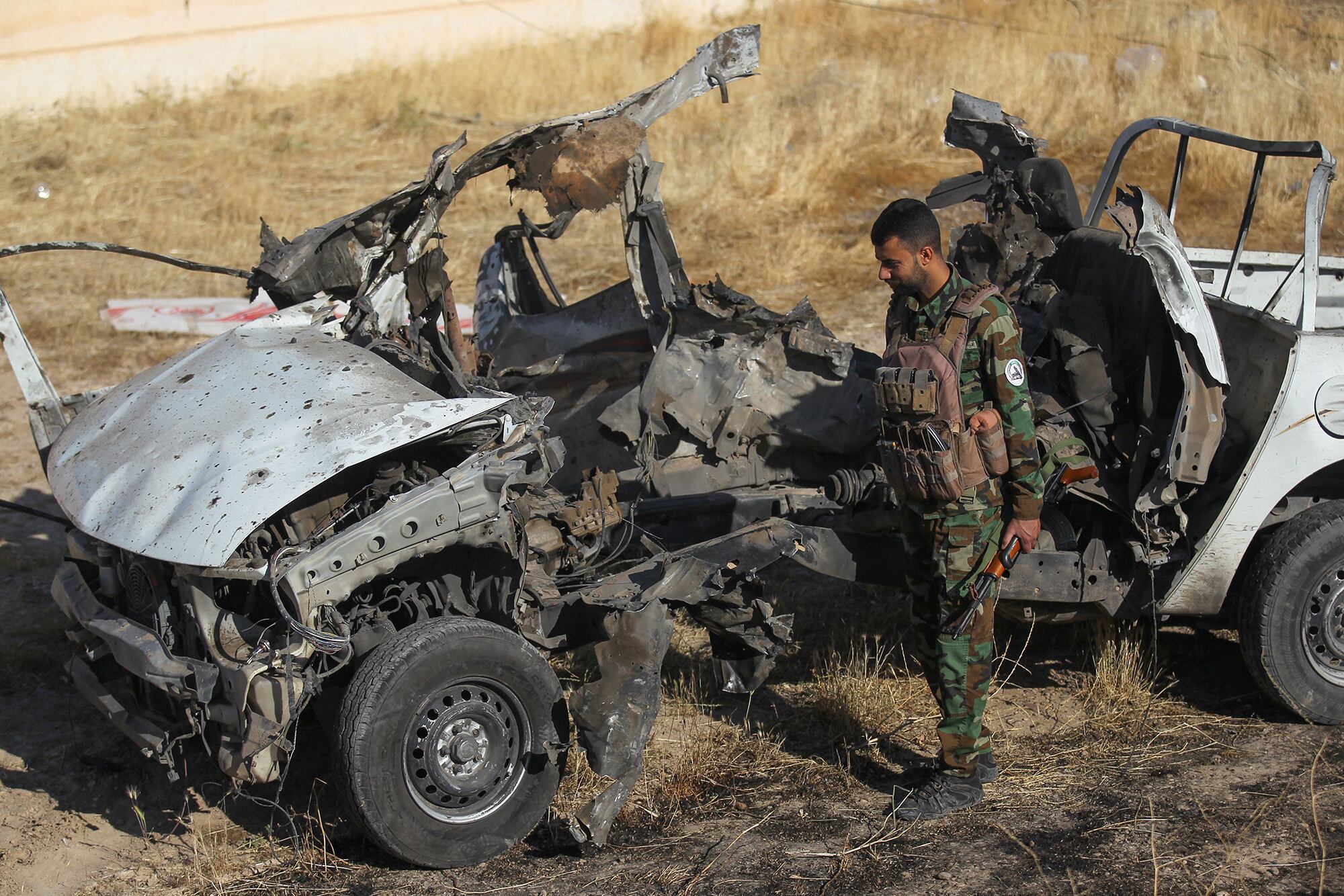 An Iraqi fighter with the Hashed al-Shaabi (Popular Mobilisation Forces) inspects the site of the Islamic State group attack a day earlier on a unit of the paramilitary force in Mukaishefah on May 3, 2020.