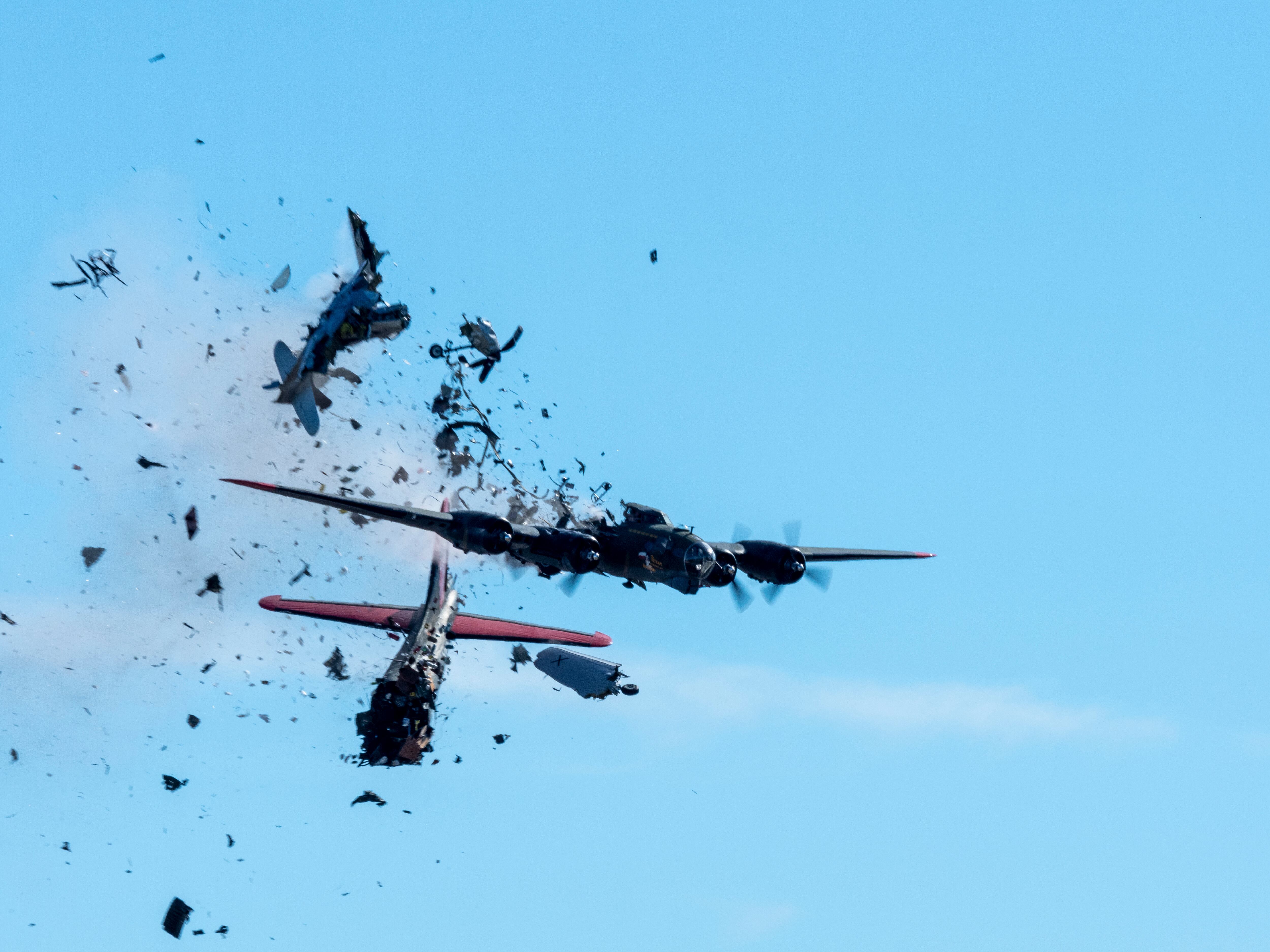 In this photo provided by Larry Petterborg, a Boeing B-17 Flying Fortress and a Bell P-63 Kingcobra collide in the midair during an airshow at Dallas Executive Airport in Dallas, Saturday, Nov. 12, 2022.