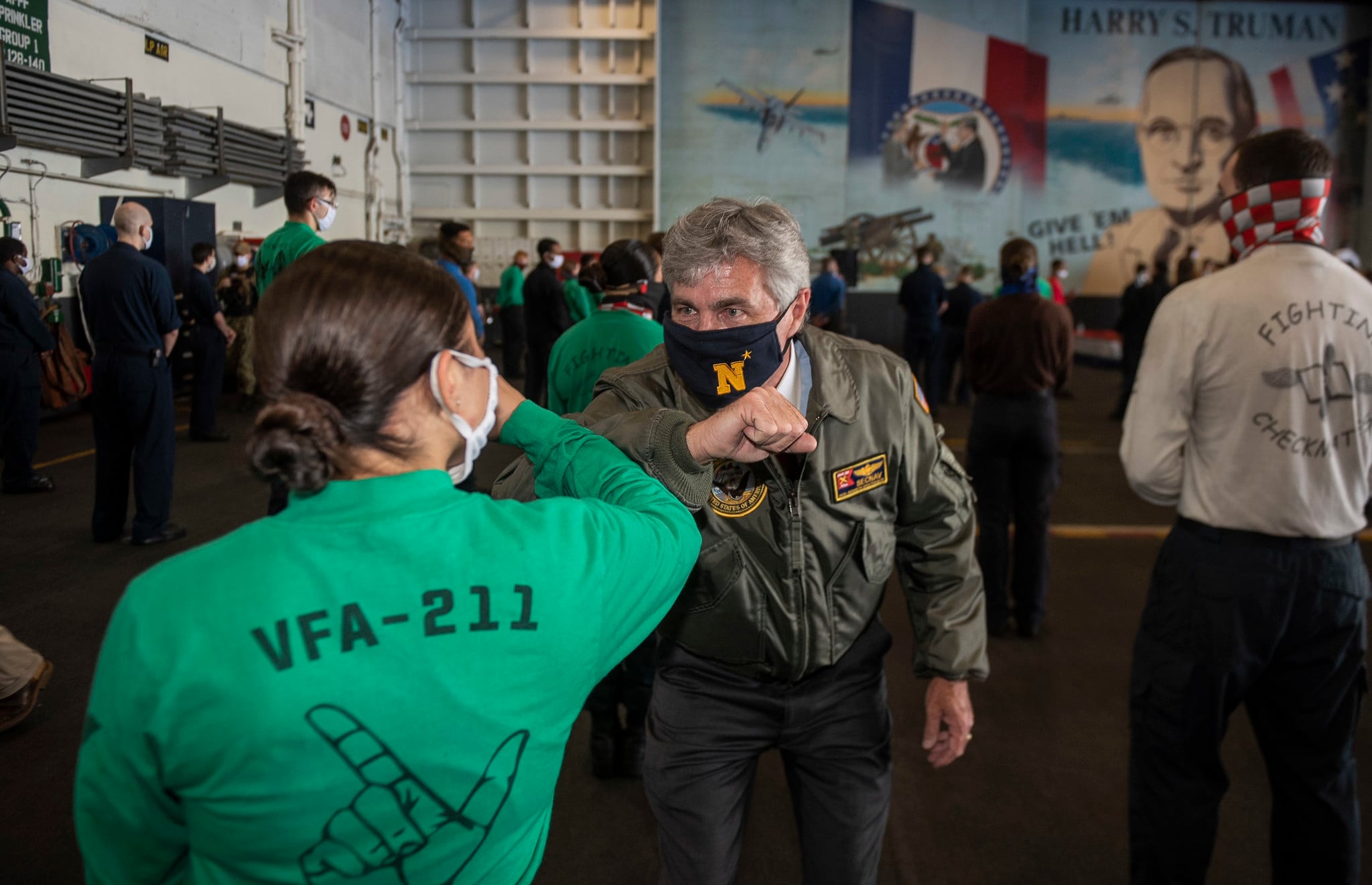 Secretary of the Navy Kenneth J. Braithwaite elbow-bumps a sailor following an all-hands call in the hangar bay of the Nimitz-class aircraft carrier USS Harry S. Truman (CVN 75) on June 4, 2020, in the Atlantic Ocean, marking his first visit as Navy secretary to a ship underway.