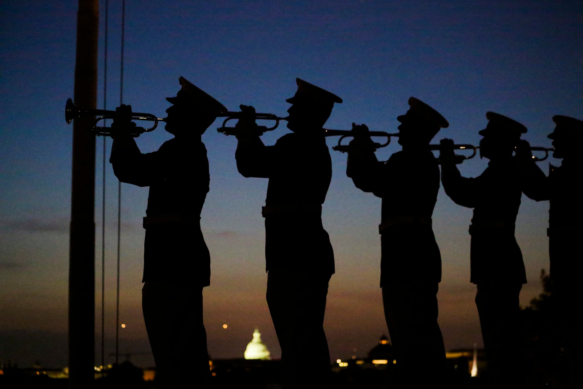 U.S. Marines with 'The Commandant’s Own' U.S. Marine Corps Drum & Bugle Corps play "Taps" during a Friday Evening Parade at Marine Barracks Washington D.C., May 25, 2018.