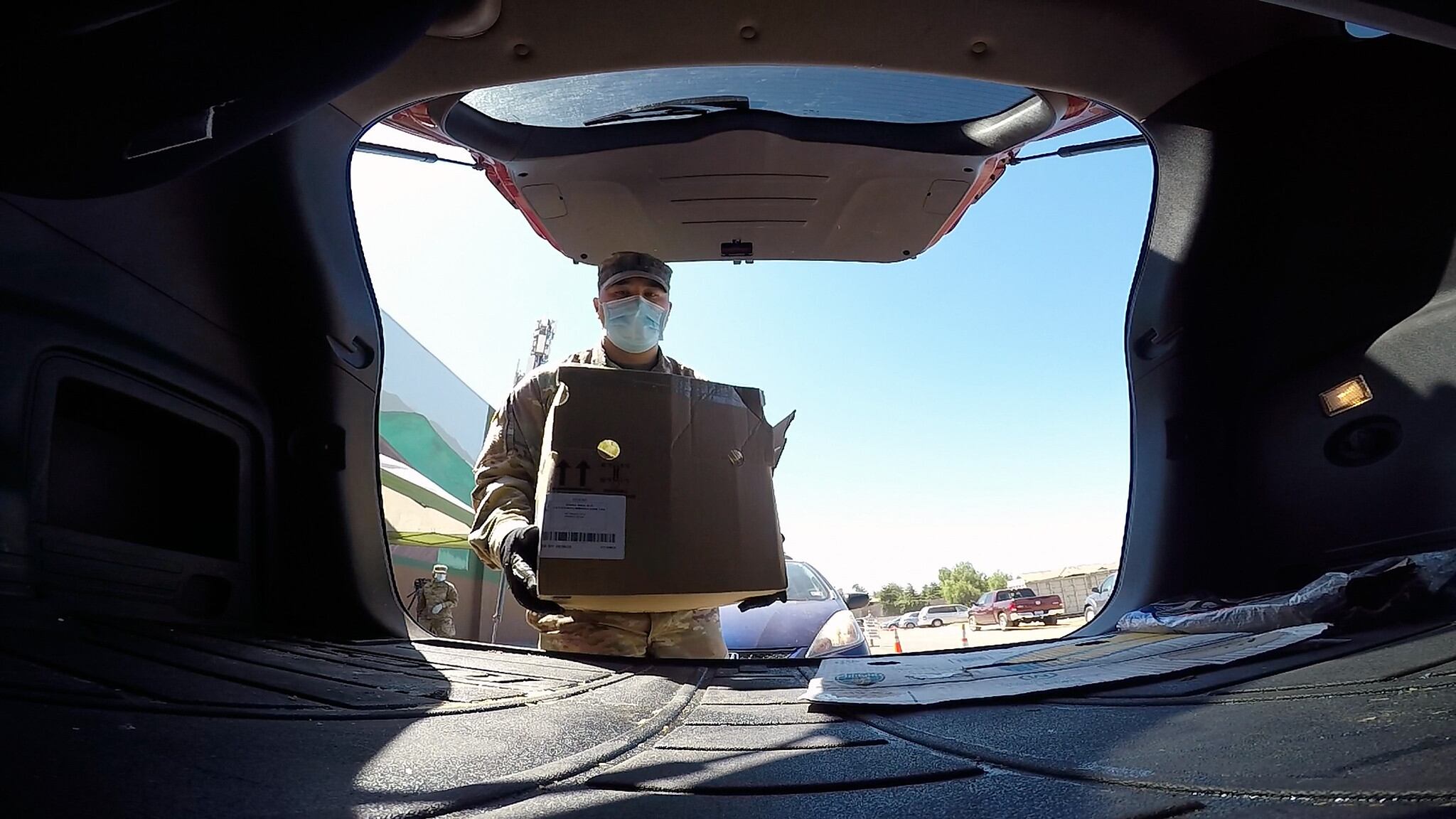 U.S. Army 1st Lt. Zachary Ota places a box of food into a vehicle Aug. 3, 2020, at the Merced County Food Bank in Merced, Calif.