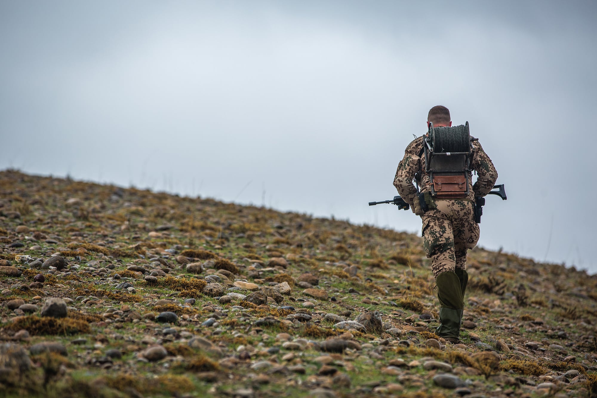 A German soldier, deployed in support of Operation Inherent Resolve, scans the ground in search of a reported unexploded ordinance in Erbil, Iraq, Feb. 13, 2018.