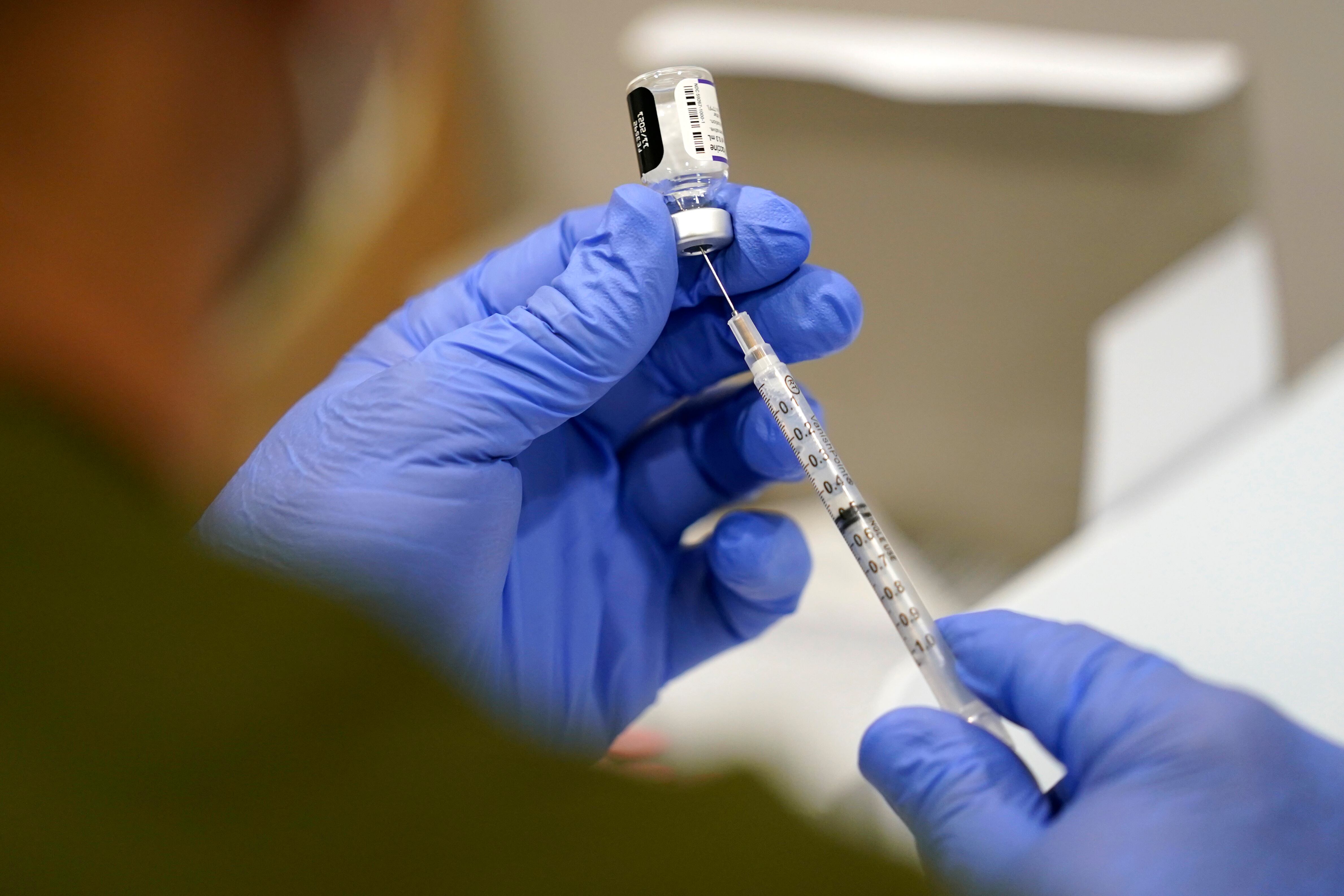 A healthcare worker fills a syringe with the Pfizer COVID-19 vaccine at Jackson Memorial Hospital on Oct. 5, 2021, in Miami.