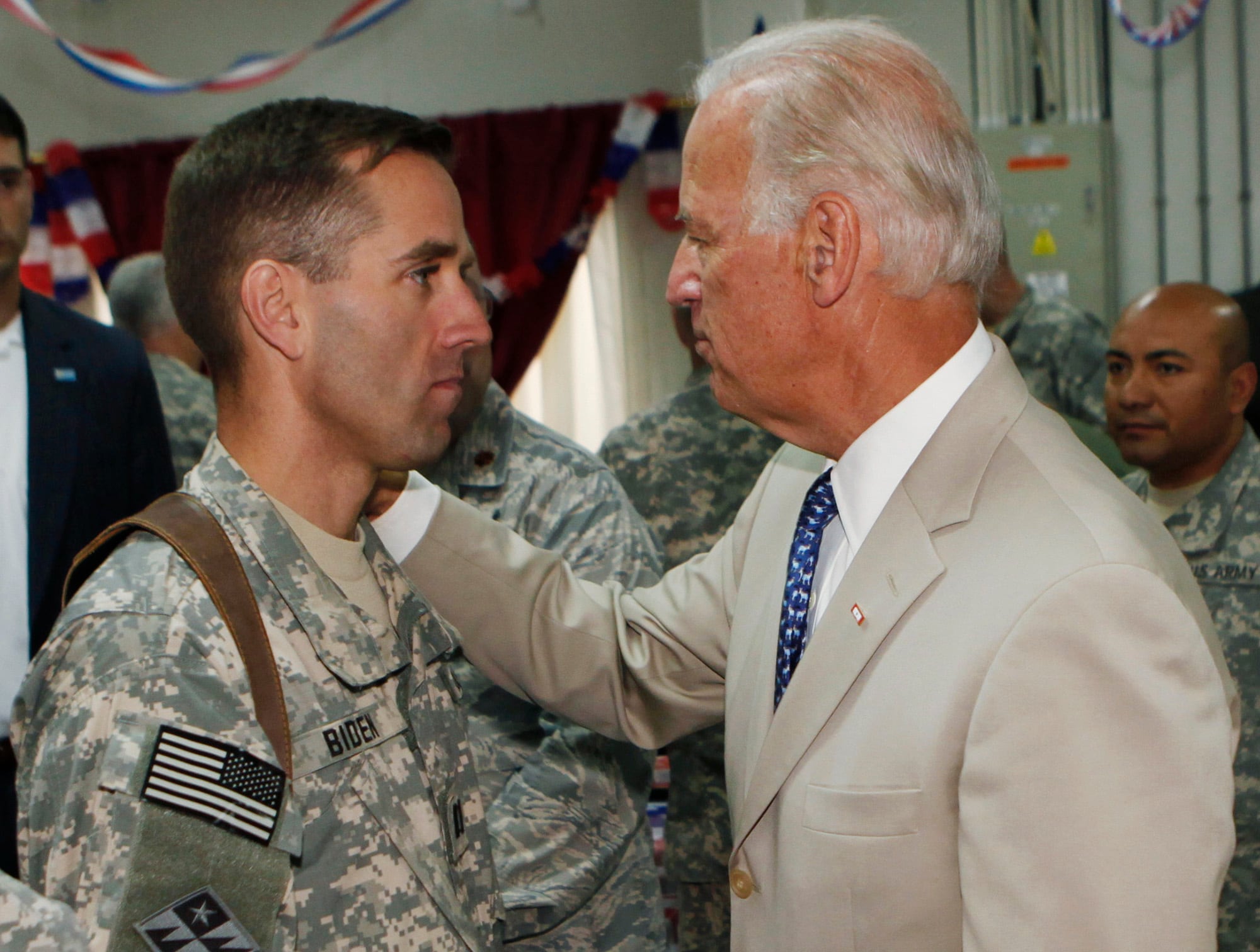 In this July 4, 2009, file photo, then-Vice President Joe Biden, right, talks with his son, Army Capt. Joseph R. "Beau" Biden III, at Camp Victory on the outskirts of Baghdad, Iraq.