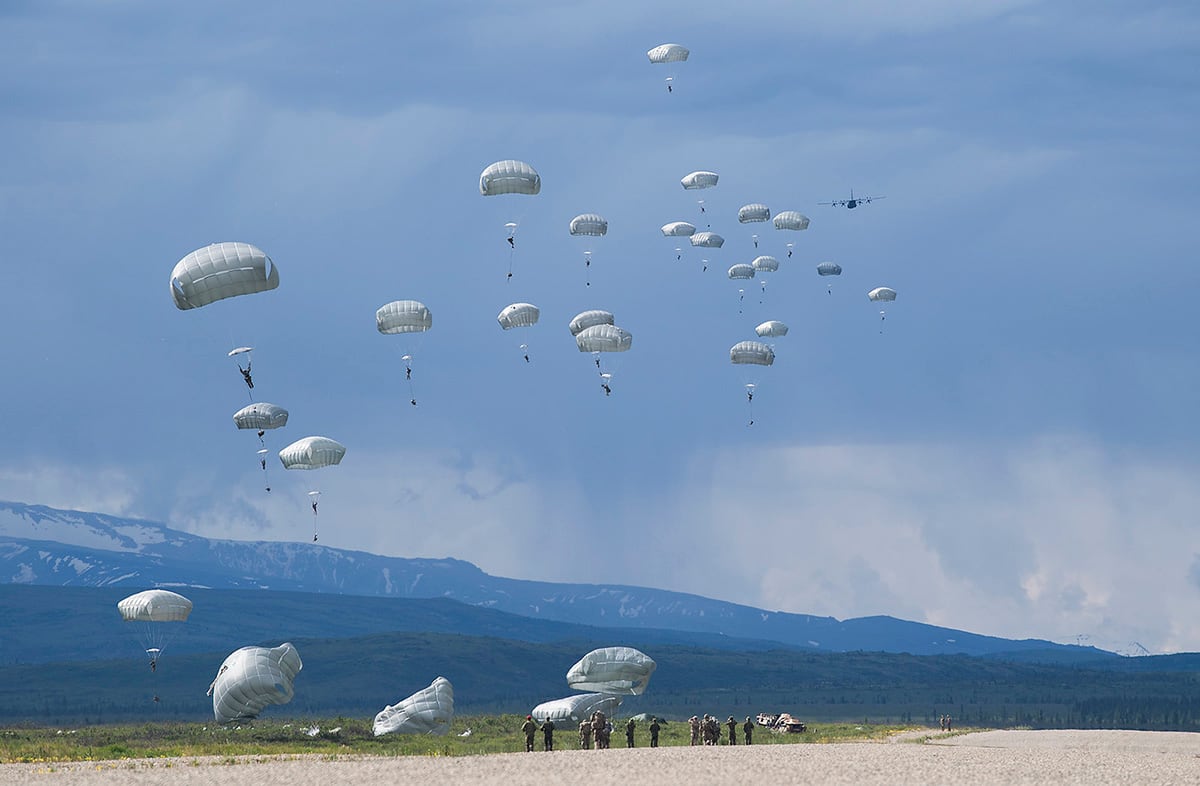 Members from the U.S. Army 377th Parachute Field Artillery Regiment complete a static line jump from a U.S. Air Force C-130 Hercules during RED FLAG-Alaska, June 13, 2019, at Donnelly Drop Zone near Fort Greely, Alaska.